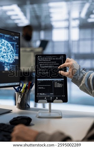 Admin uses machine learning applications on tablet to optimize data center operations, improving efficiency, ensuring longevity of infrastructure. Worker implementing server virtualization with device