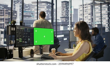 Admin using multi monitor green screen PC to create machine learning models that can process data to automate decision making processes. Woman programming using chroma key computer