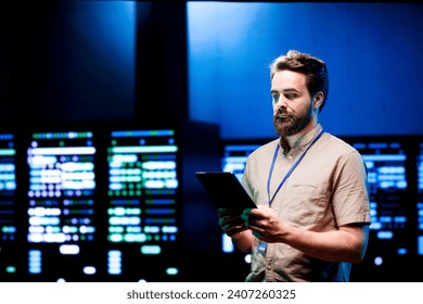 Admin walking in data center supporting AI through powerful computing operations, hosting specialized storage servers. Engineer ensuring high tech facility internal hardware functions properly