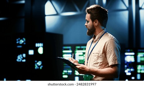 Admin walking in data center supporting AI through high performance computing, hosting specialized storage and networking hardware. Engineer ensuring server room internal hardware functions properly