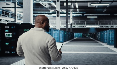 Admin walking in high tech data center facility, checking equipment for system stability. IT specialist overseeing server room, configuring supercomputers, optimizing performance, camera A