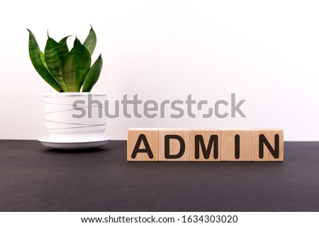 ADMIN word built with letter cubes on a black table