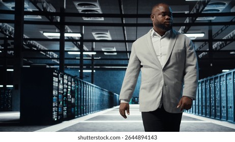 Admin working in high tech server hub capable of processing and storing vast amounts of data. African american IT specialist troubleshooting server rows controlling network resources, camera A