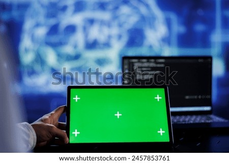 Admin writes code on green screen tablet to visualize artificial intelligence neural networks using augmented reality. High tech workspace supervisor runs AI script on chrome key device