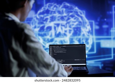 Admin writes code on laptop to visualize artificial intelligence neural networks made up of interconnected nodes using augmented reality technology. Expert running AI script for data processing