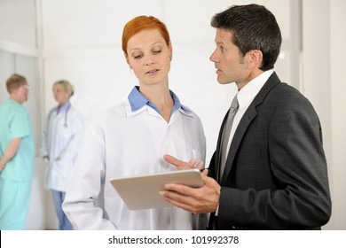 Administrator talking with Doctor at the Hospital