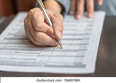 Administrator's Hand Fill In Business Schedule Form Document Writing On Yearly Work Plan, Monthly Timetable Sheet, Or Weekly Time Table Paper For Office Tasks, Things And Jobs To Do List