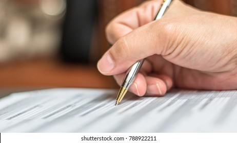 Administrator's Hand Fill In Business Schedule Form Document Writing On Yearly Work Plan, Monthly Timetable Sheet, Or Weekly Time Table Paper For Office Tasks, Things And Jobs To Do List