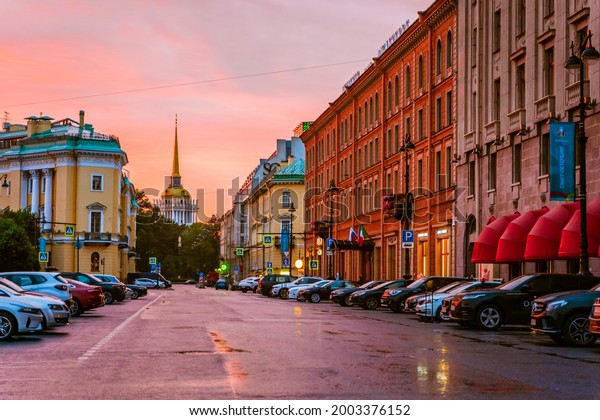 The\
Admiralty Tower was photographed in a stream of cars at a bright\
red sunset. Saint Petersburg, Russia - 28 June\
2021