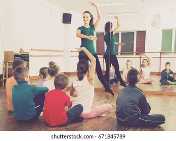 admiring children primary school age rehearsing ballet dance in studio