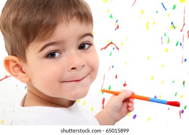 Adoable 2 Year Old Boy Painting Close Up Face.