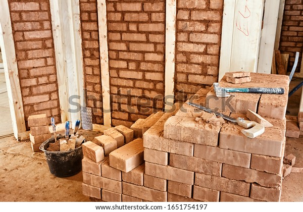 Adobe bricks filling the compartments of the\
framework of an eco