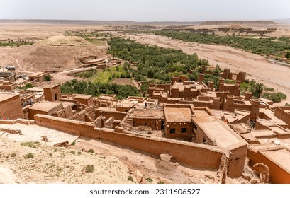 Adobe buildings and the surrounding landscape as seen from above at the archaeological site of Ait Ben Haddou in Morocco. - Shutterstock ID 2311606527