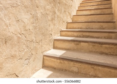 An Adobe Flight Of Stairs Against A Plaster Wall Of The Courtyard Of A Traditional Arabian House.