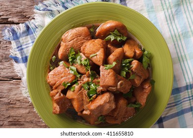 Adobo Chicken with herbs close-up on a plate on the table. horizontal view from above