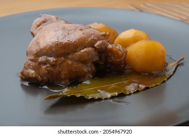 Adobo chicken with potatoes and a bay leaf