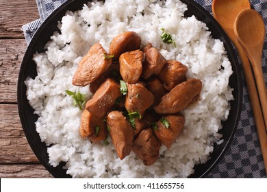 Adobo Chicken with a side dish of rice close-up on a plate. horizontal view from above