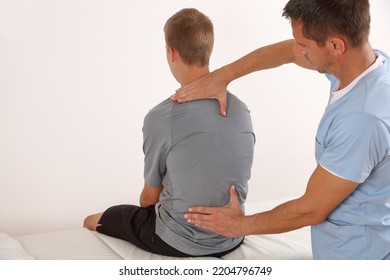 Adolescent Scoliosis Posture Correction. Physical therapy and diagnostics. Doctor and teenage patient - Powered by Shutterstock