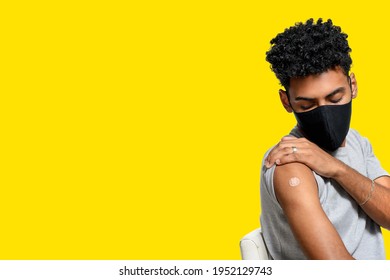  adolescent shows patch after receiving immunization , vaccination of adolescent isolated on yellow background - Powered by Shutterstock