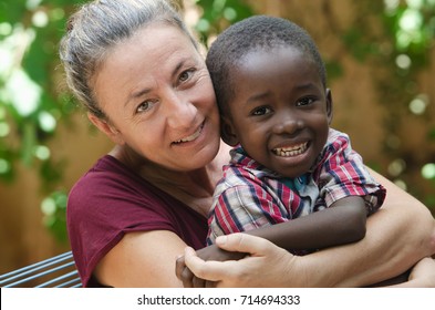 Adoption symbol - Woman adopts a little African boy
