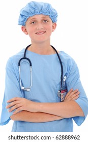 Adorable 12 Year Old Boy Dressed In Surgical Scrubs Over White Background.