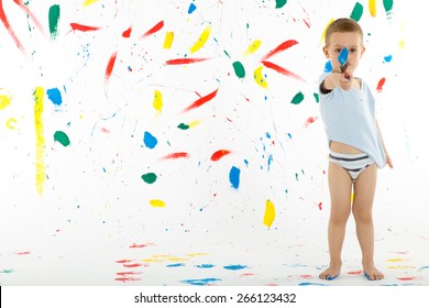 Adorable 3 Year Old Boy Child Creatively Stains On The Wall, Floor With Colourful Paint. Mess Of Paint On Wall, Floor And Everywhere.