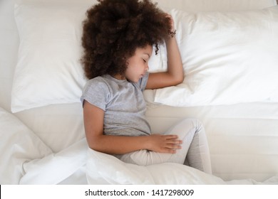 Adorable African American Girl Sleeping Well In Cozy Bed, Cute Little Kid Lying On Soft Pillow Napping Alone, Calm Black Child Resting In Good Night Healthy Peaceful Sleep In Bedroom, Top View Above