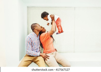 adorable african family lifting up the baby
