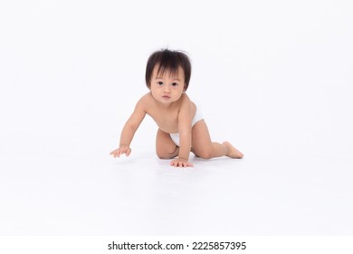 Adorable Asian Baby In Diaper Sitting And Crawling Isolated White Background. Happy Little Baby Boy Smile Playing And Enjoy With Himself. Healthy And Strong Baby Learning To Crawing And Walking.