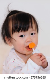 Adorable Asian Baby Girl  Eating Candy