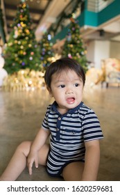 Adorable Asian Boy Toddler Sitting Down And Having A Tantrum And Negative Emotions