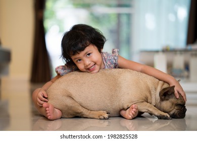 Adorable Asian Girl Sitting With Sleeping Dog On Lap At Home, Quarantine Concept.