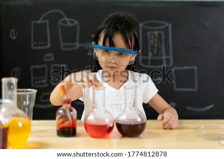 Adorable asian little girl is make easy scientific experimental at home, concept of learn from home, child STEM education and science for kid.