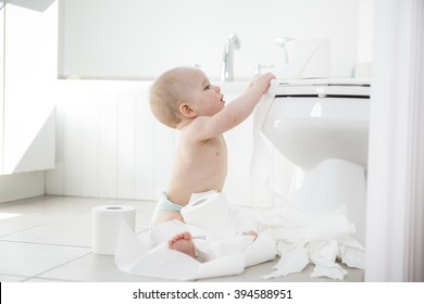 An Adorable Baby Boy Playing With Toilet Paper