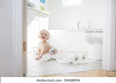 An Adorable Baby Boy Playing With Toilet Paper