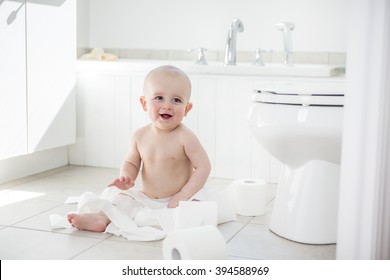 An Adorable Baby Boy Playing With Toilet Paper