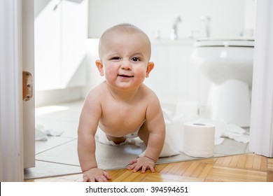 An Adorable Baby Boy Playing With Toilet Paper