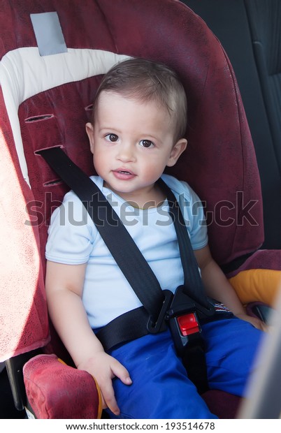 Adorable baby boy  in safety\
car seat