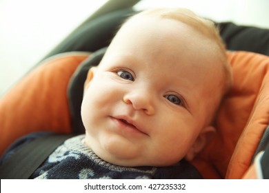 Adorable Baby Boy Sitting In Car Seat