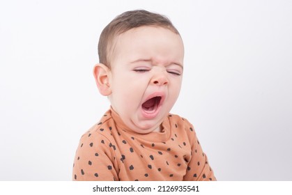 Adorable Baby Boy Wearing Animal Print Sweater Over White Background Feeling Tired And Yawning, It's Time To Take A Nap. 