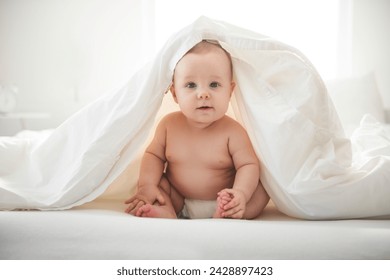 An Adorable baby boy in white sunny bedroom. - Powered by Shutterstock