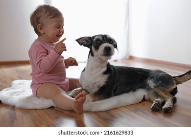 Adorable Baby And Cute Dog On Faux Fur Rug Indoors