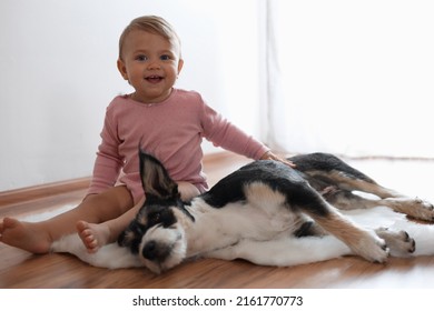 Adorable Baby And Cute Dog On Faux Fur Rug Indoors