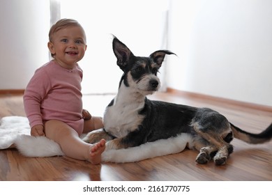 Adorable Baby And Cute Dog On Faux Fur Rug Indoors