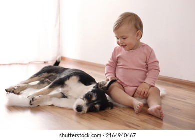 Adorable Baby And Cute Dog On Faux Fur Rug Indoors