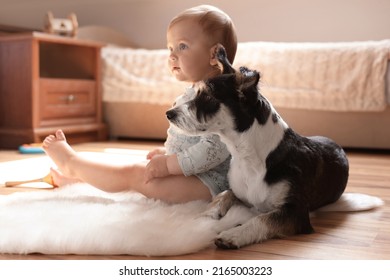 Adorable Baby And Cute Dog On Faux Fur Rug At Home