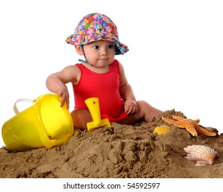 An Adorable Baby Girl In A Bathing Suit And Sunhat Playing In The Sand.  Isolated On White.