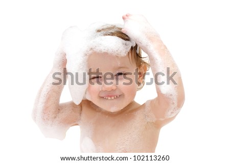 Adorable baby girl with soap suds on hair taking bath. Closeup portrait of smiling kid, health care and hygiene concept as logo. Isolated on white background with clipping path.