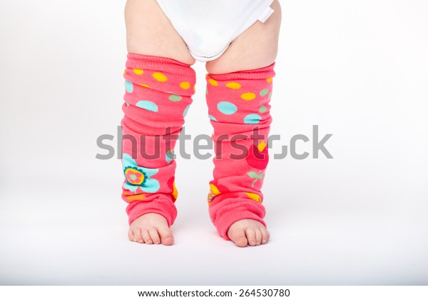 Adorable baby girl\
wearing baby leg warmers\
