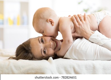 Adorable Baby Kissing His Mother. Young Woman And Little Child Have A Fun Pastime.